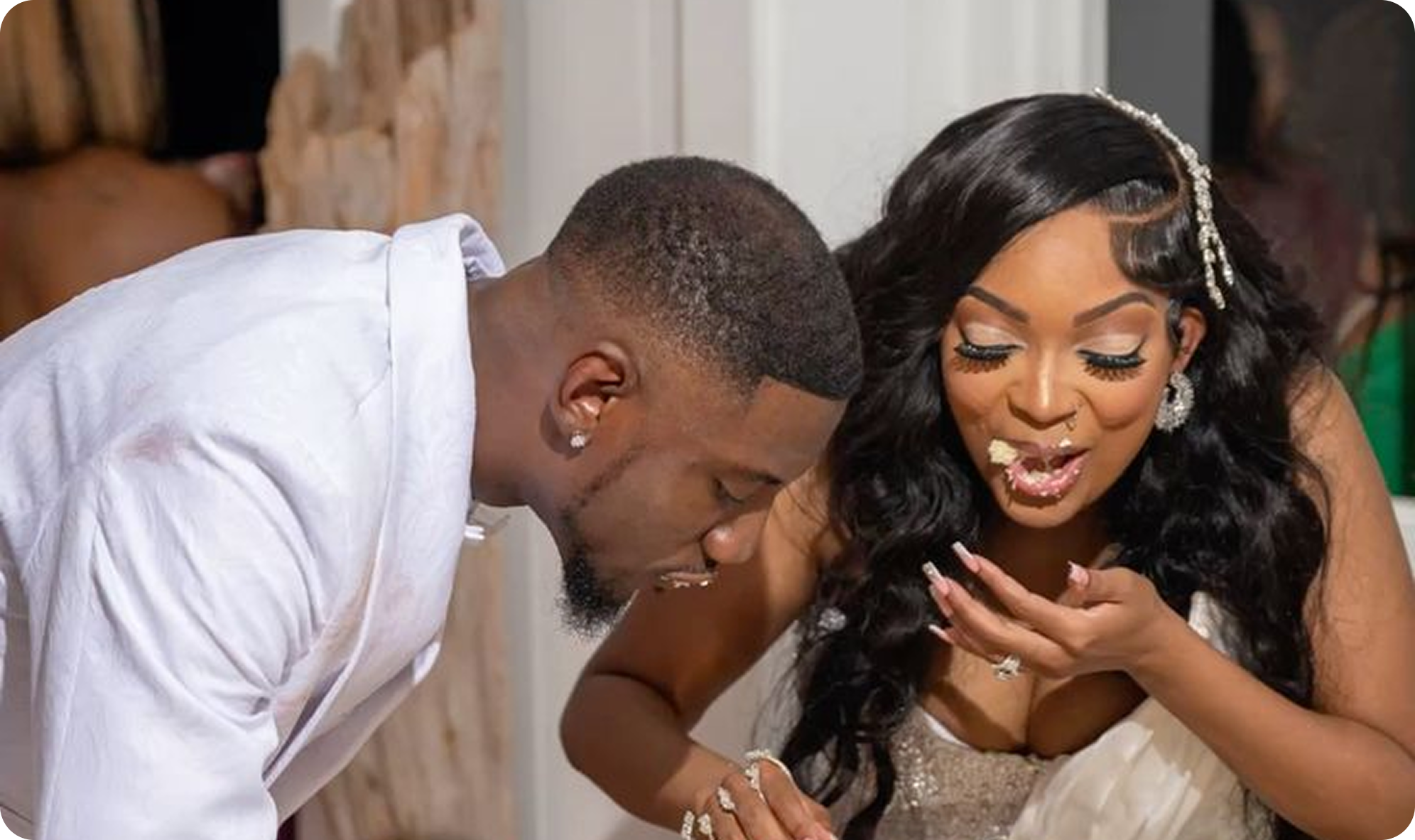 African wedding couple feeding each other cake